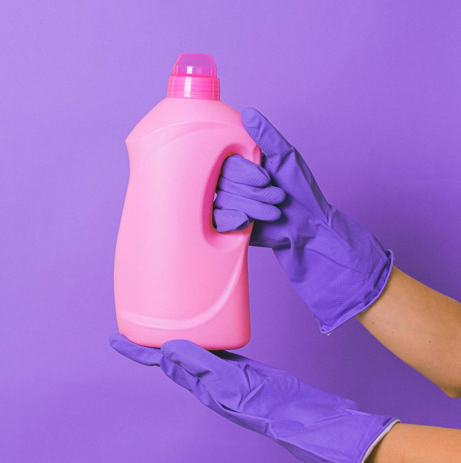 Crop person with detergent in studio