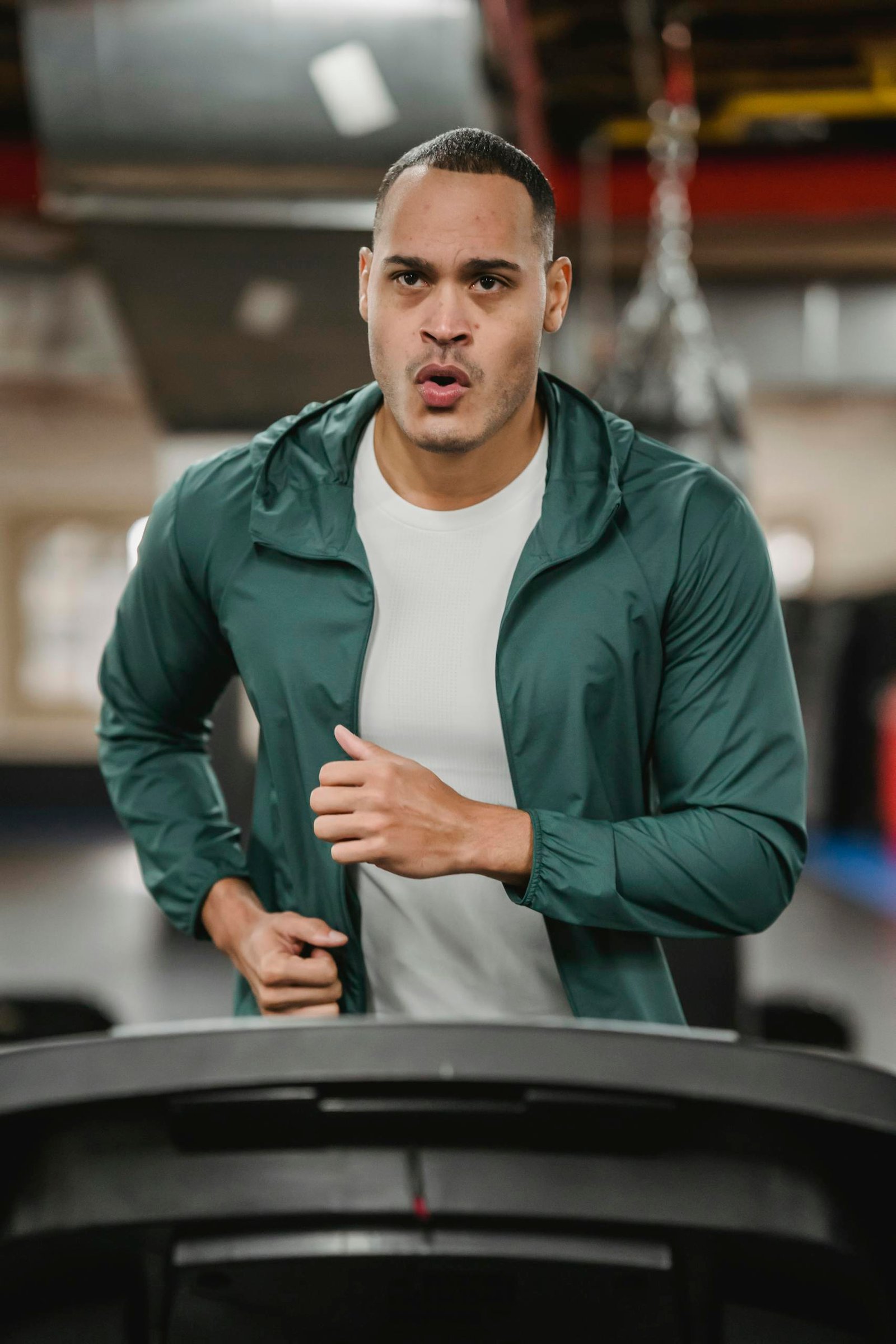 Enduring man running fast on treadmill