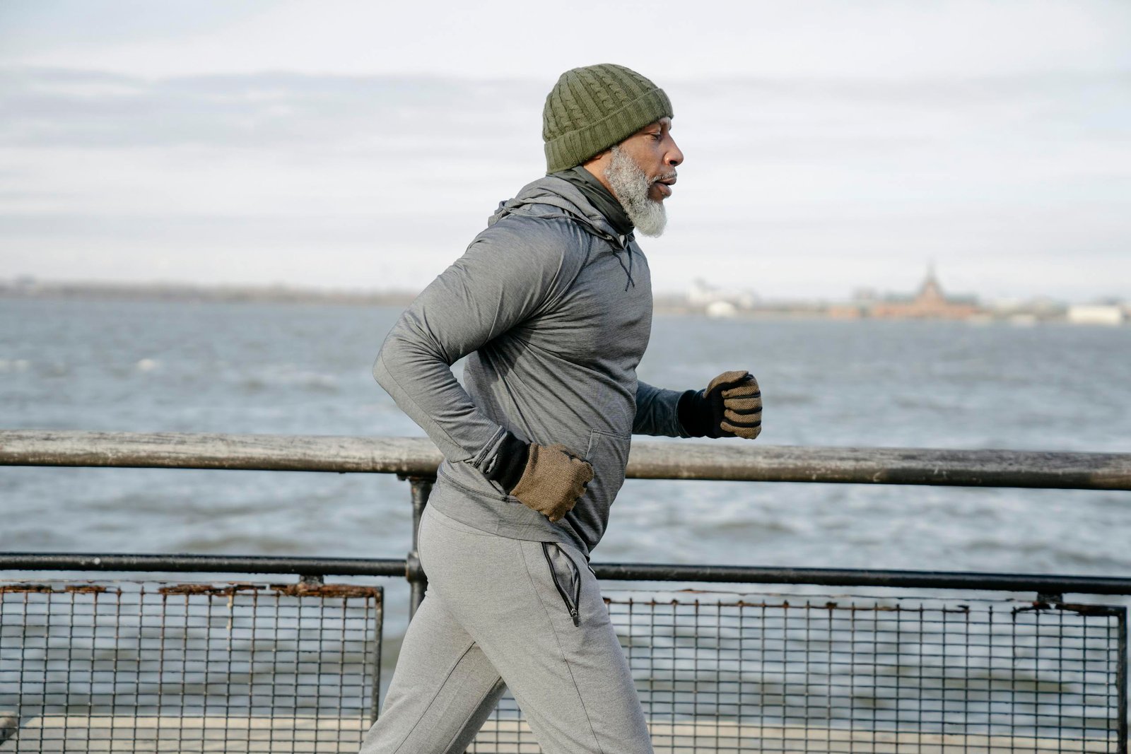 Old black man running near water