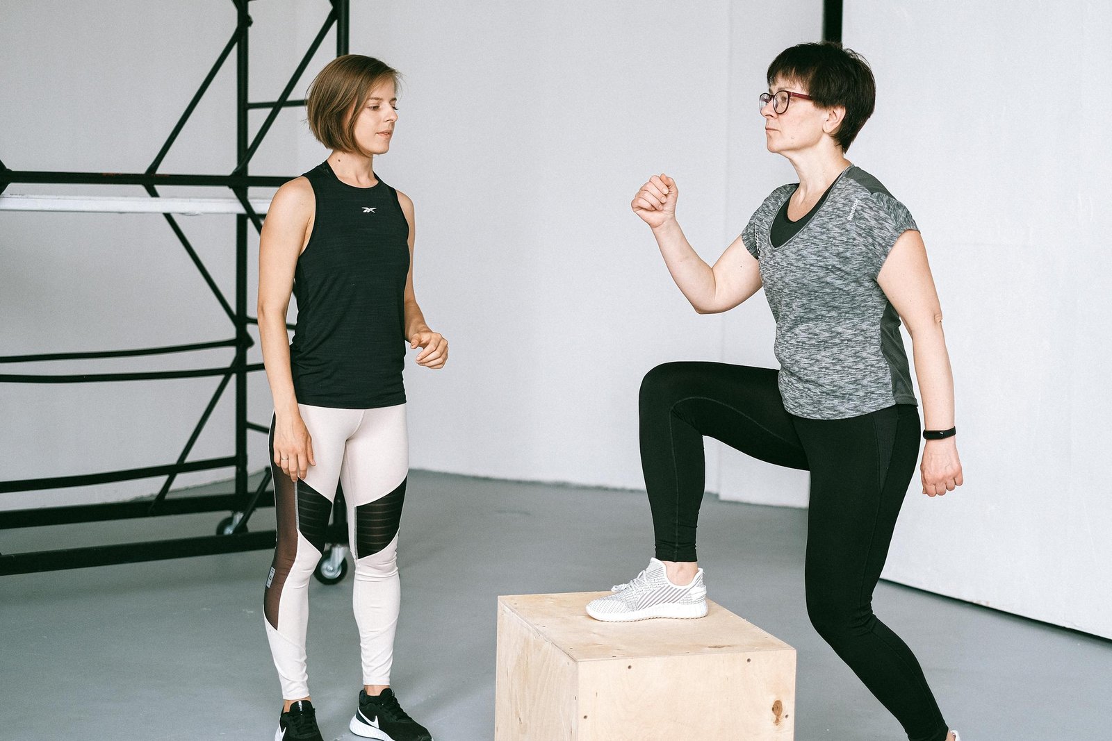 An Elderly Woman Exercising Under the Watch of a Fitness Coach