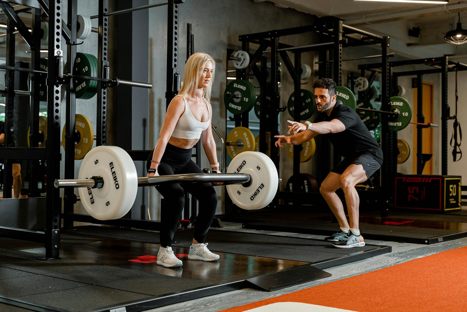 Woman Holding Barbell at Gym